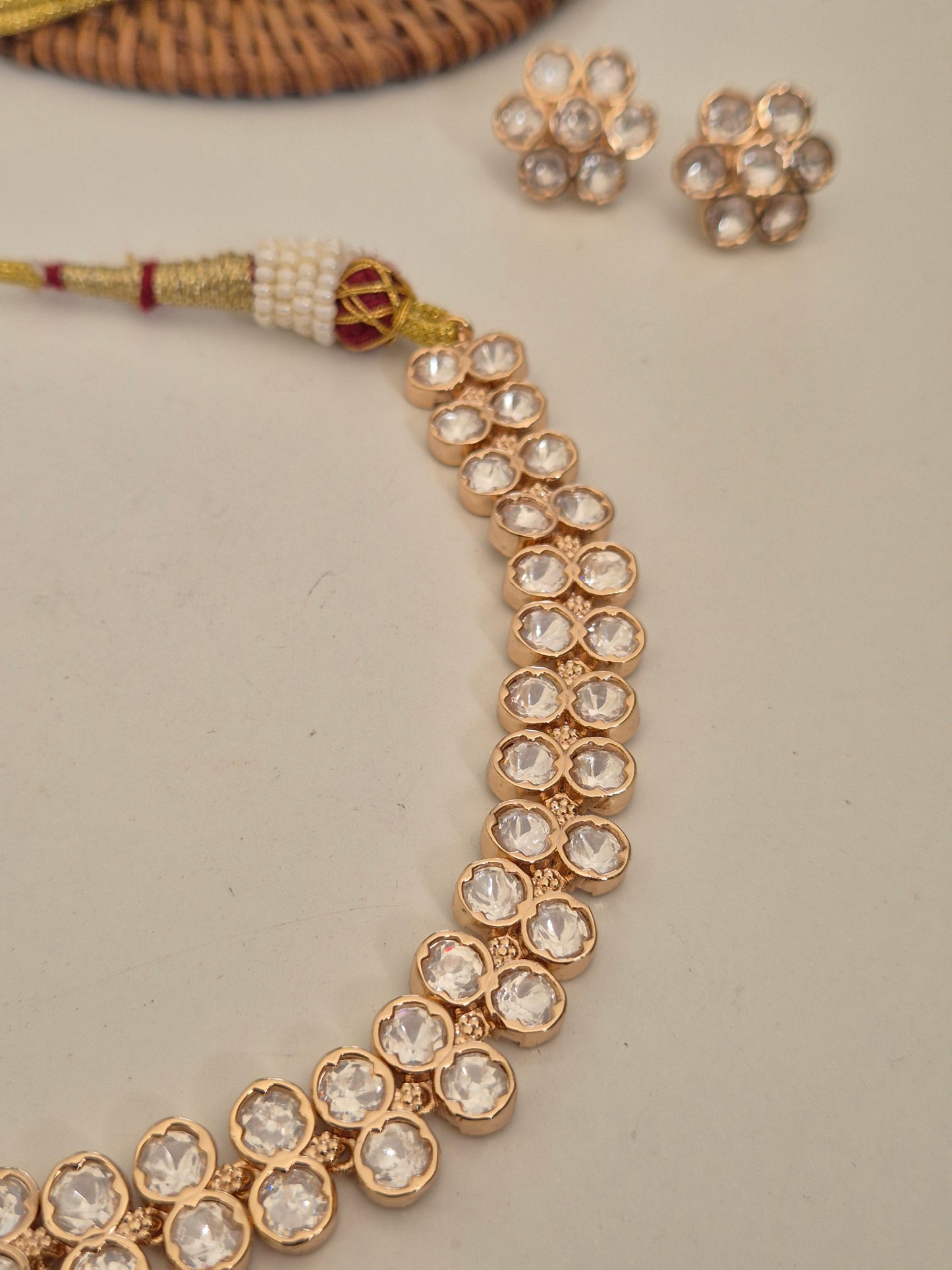 Modern Indian rose gold choker necklace featuring double-layered American diamond crystals and matching flower studs by naitri.in