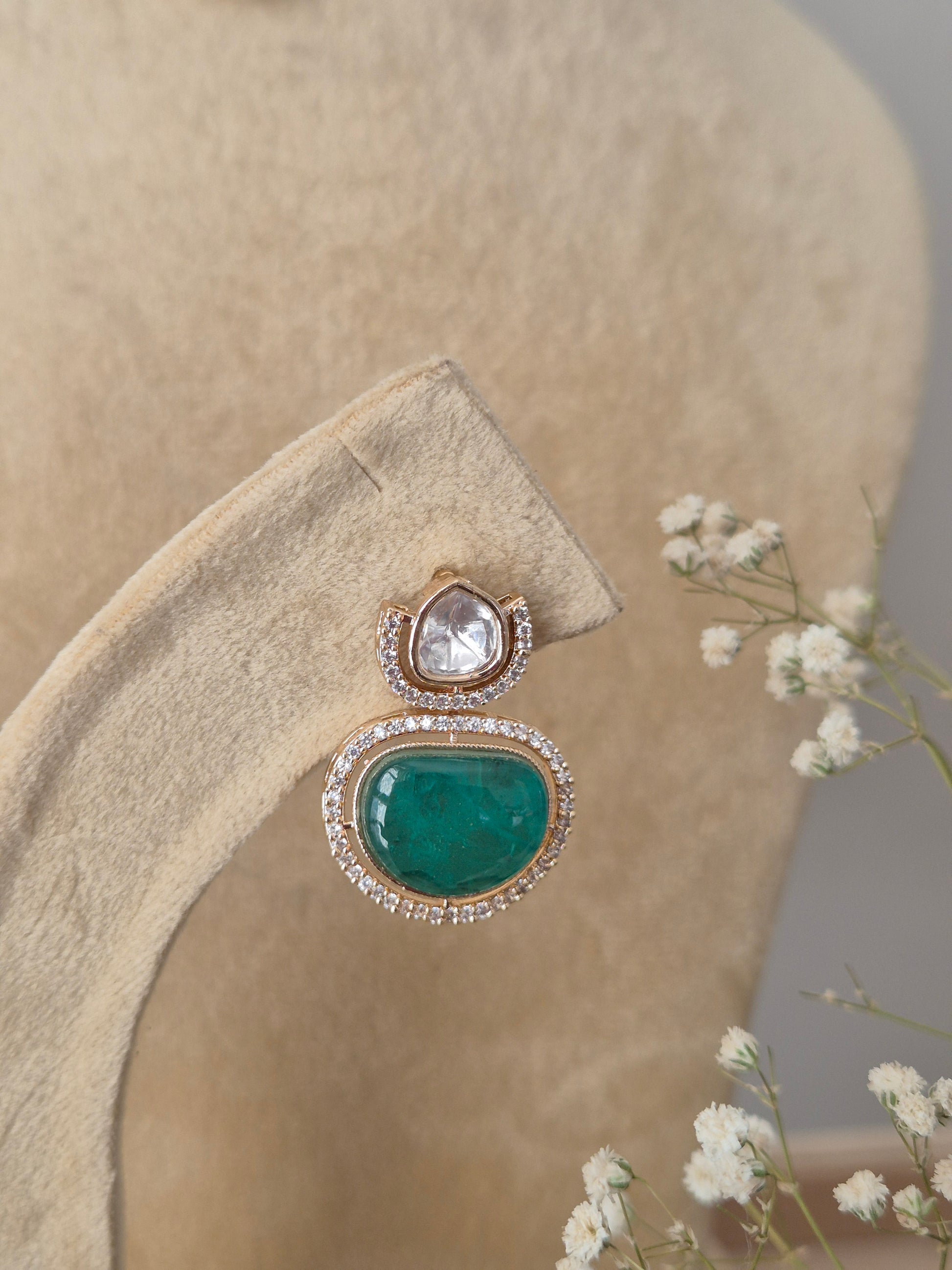 Rose-Gold toned necklace with clear crystals and a green center stone, with matching earrings by naitriin