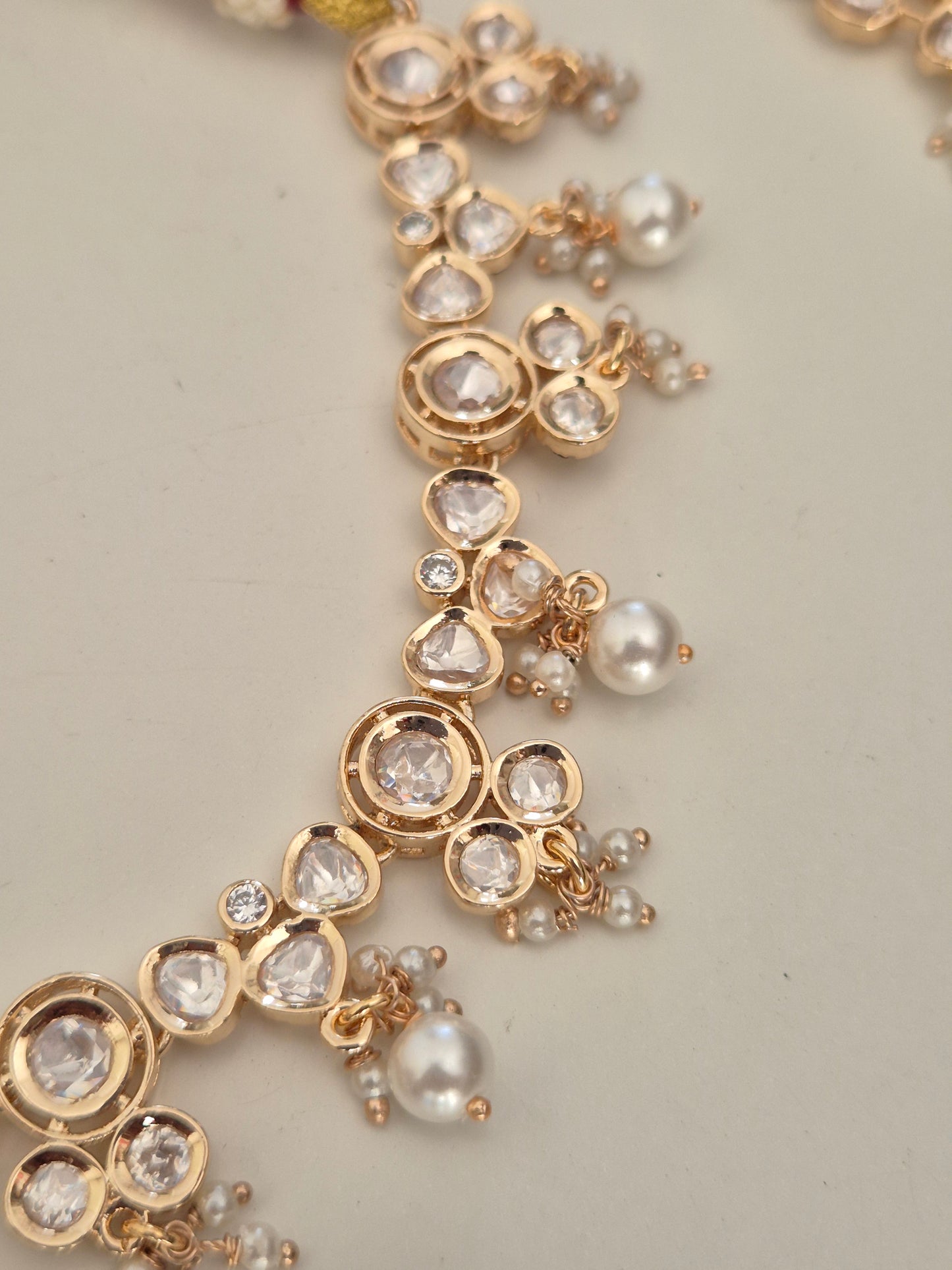 Statement festive necklace set with clear AD crystals and small pearls, perfect for weddings and sarees by naitri.in
