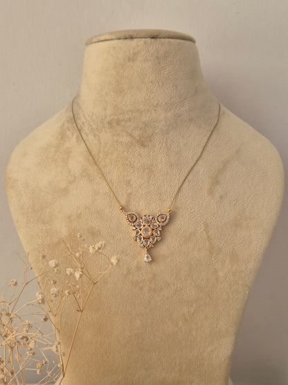 Ruma Invisible Chain Necklace featuring a delicate gold chain and traditional pendant with polished stone accents, displayed on a mannequin by Naitri.in