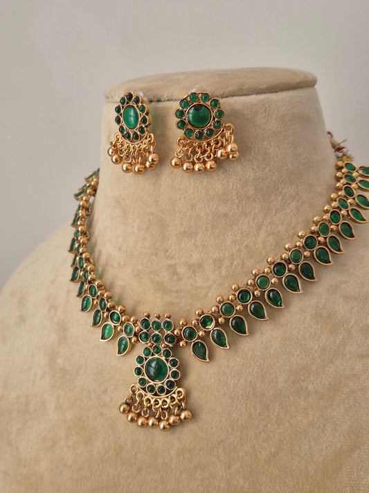  Gold-finish brass alloy necklace with emerald-green stones and matching earrings by naitri.in