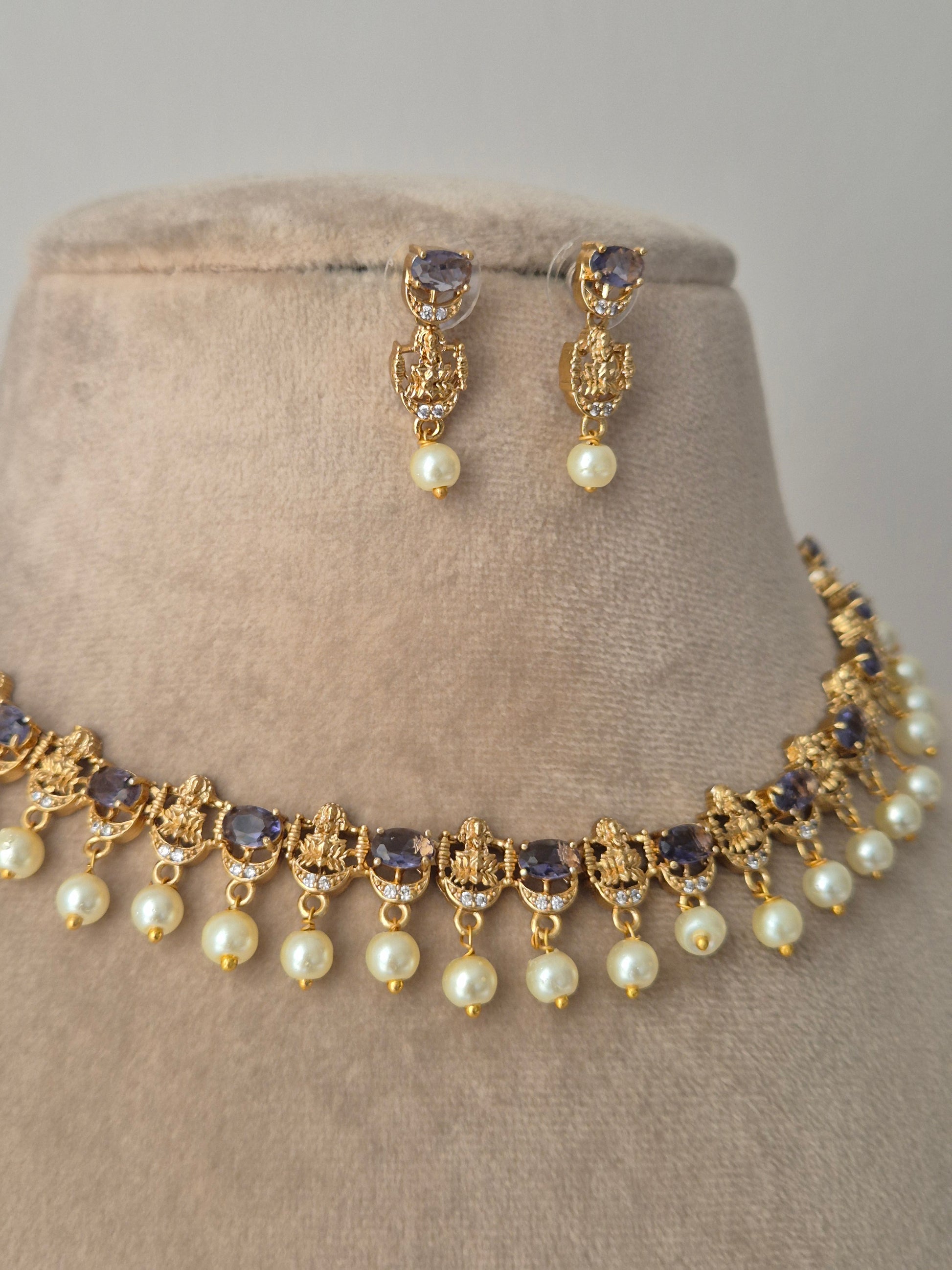Gold necklace with purple stones hanging white pearls minimal design of goddess with small stones by naitri.in