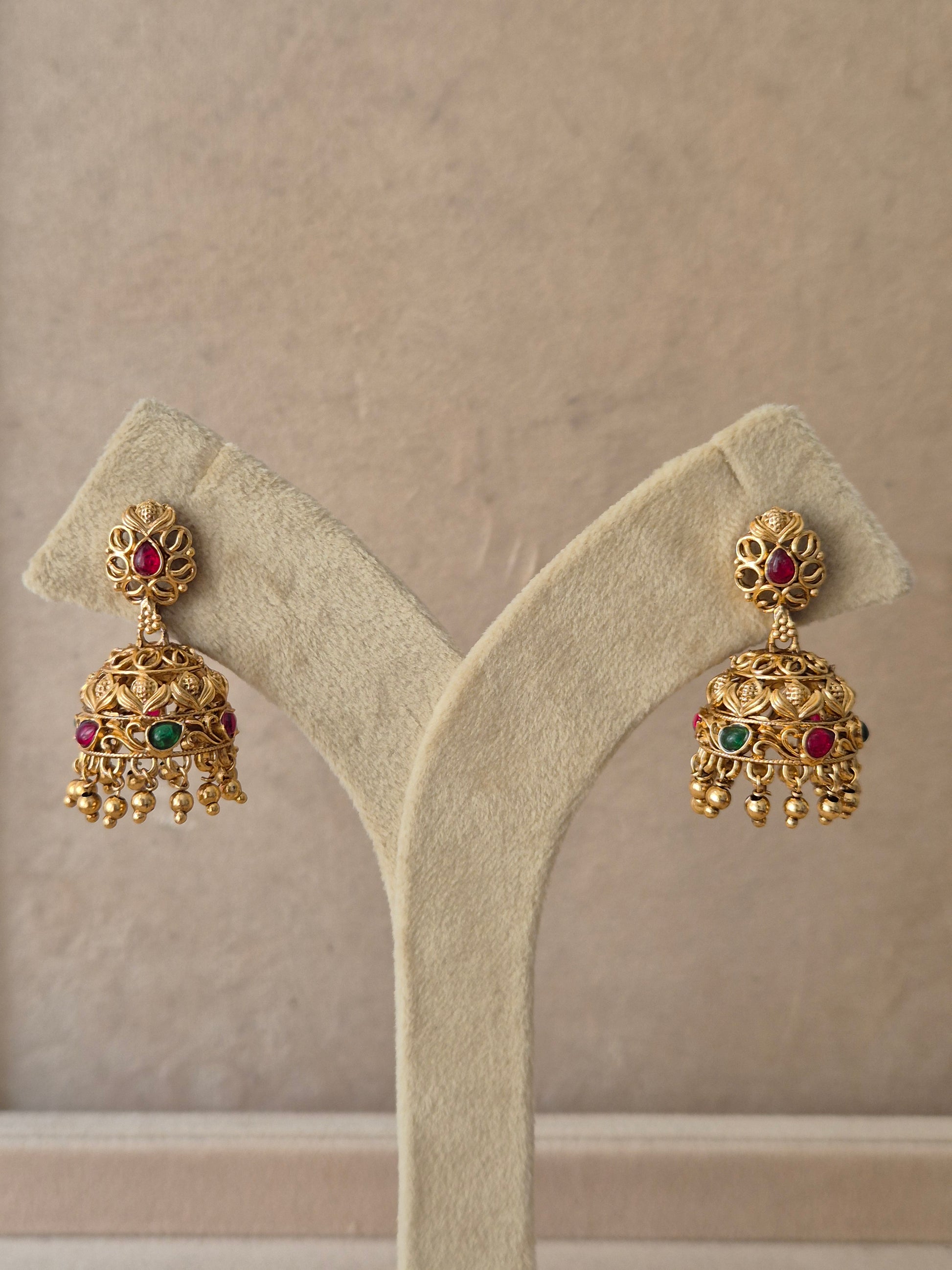 Handcrafted traditional Indian gold Jhumka earrings by Naitri, featuring ethnic dangle designs and gemstone embellishments by naitri.in