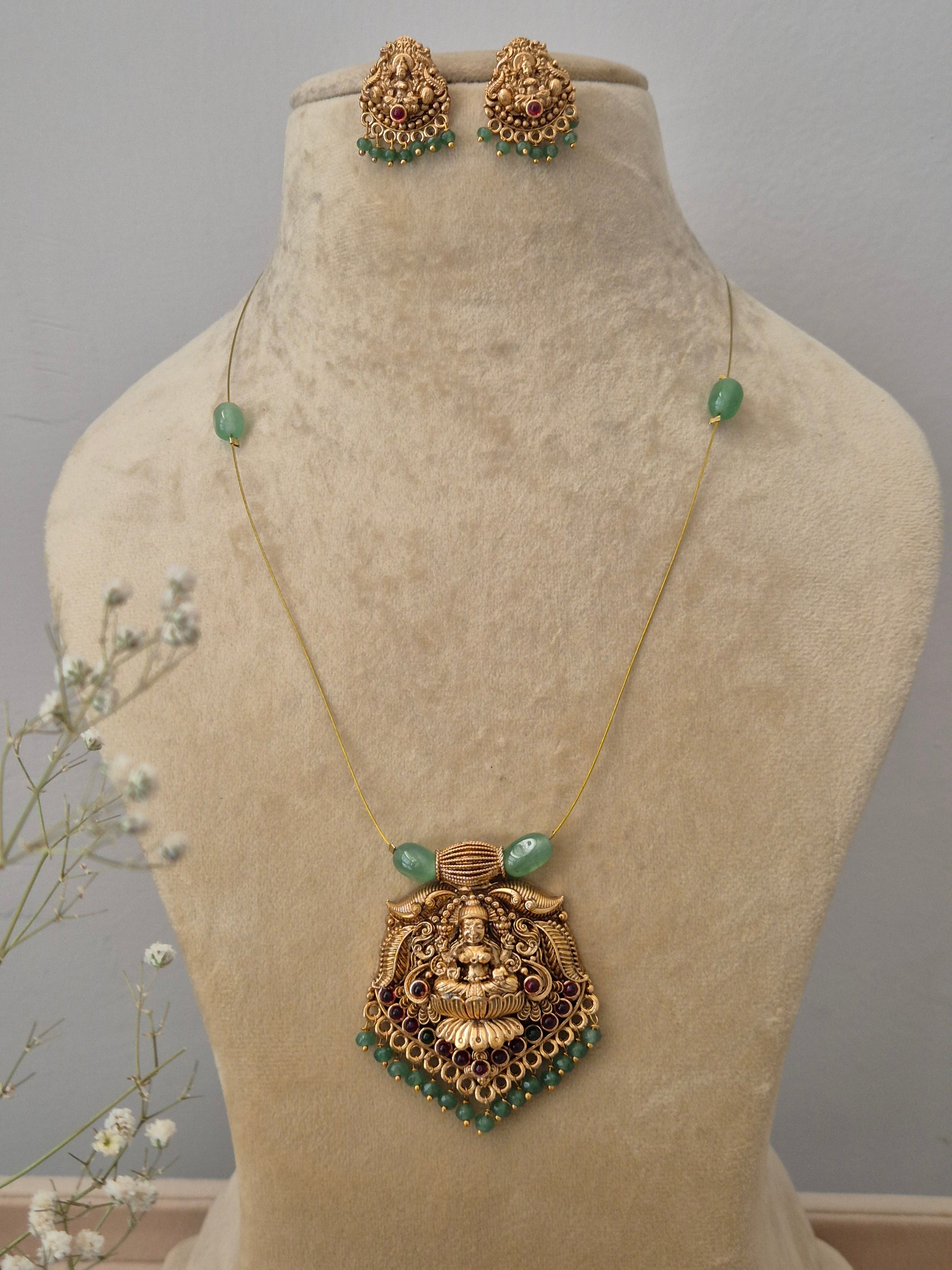 Gold Temple jewelry necklace and matching earrings set with green beads, by naitri.in