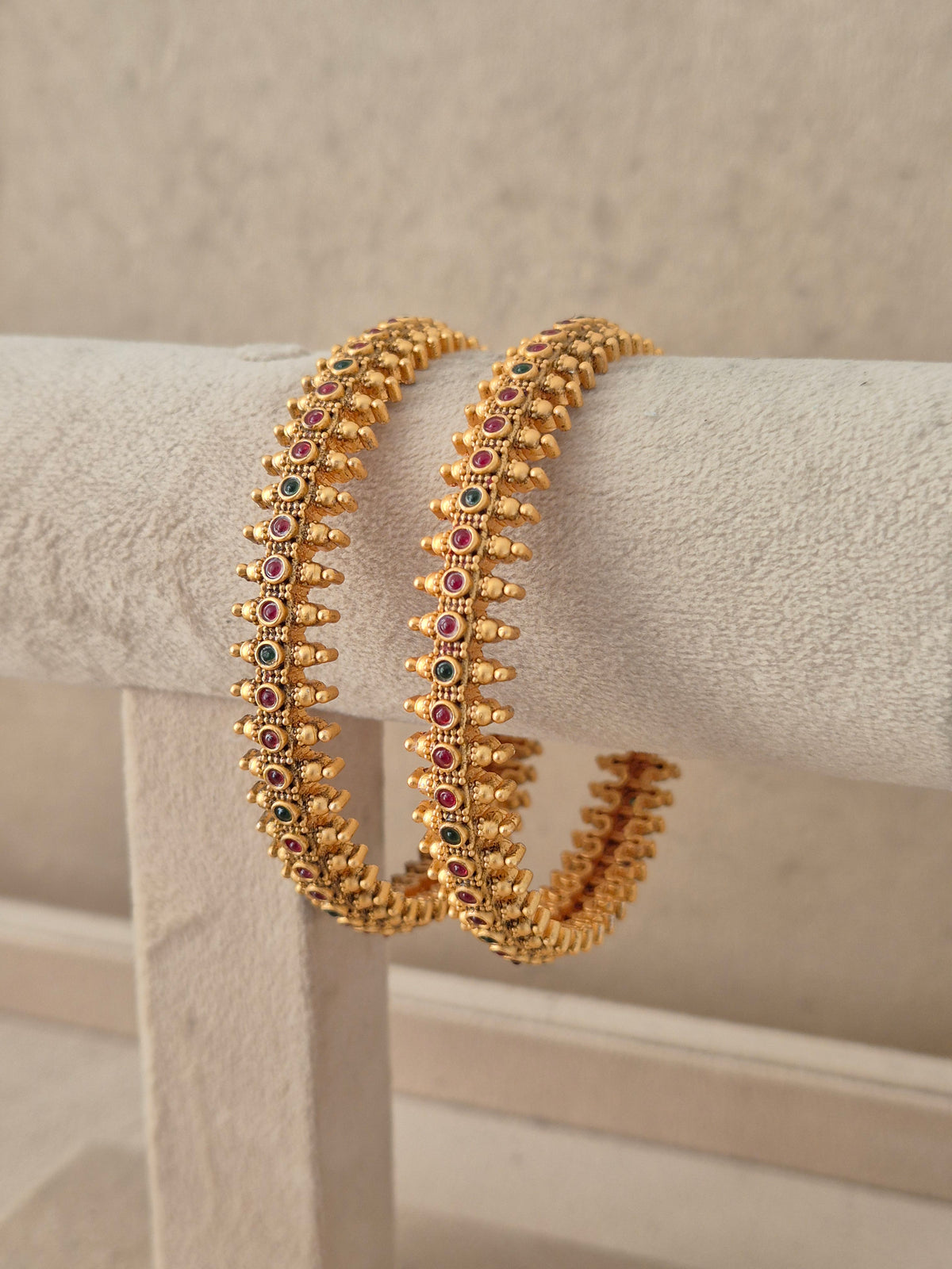 Elegant festive Indian gold-plated bangles featuring intricate fine relief crafting for weddings and special occasions by naitri.in