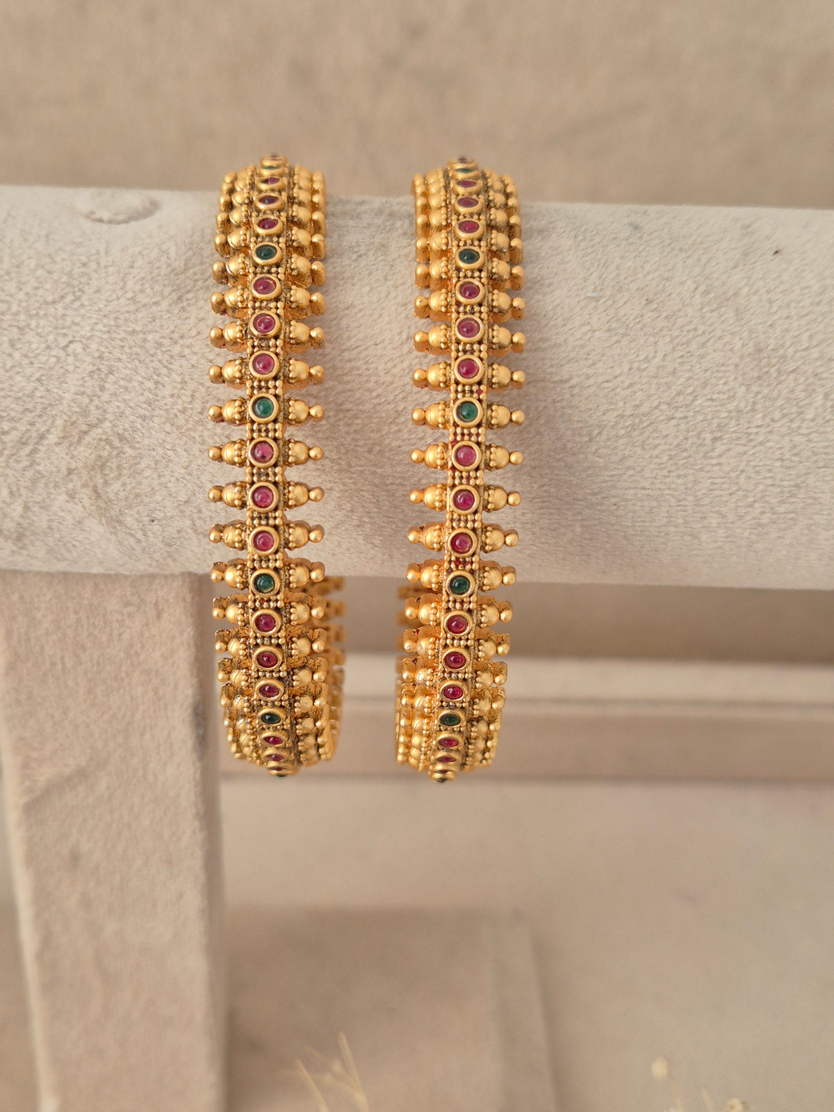 Set of two textured gold-plated ethnic bangles by naitri.in