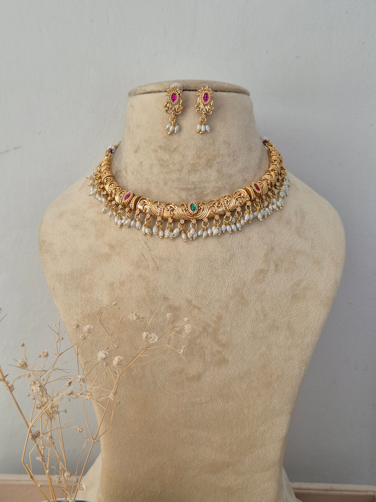 Santoshi handcrafted gold-finish necklace set with ruby stones, green accents, and pearl hangings by naitriin