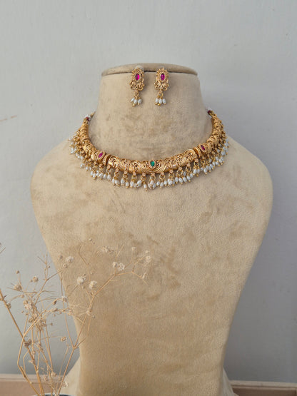 Santoshi handcrafted gold-finish necklace set with ruby stones, green accents, and pearl hangings by naitriin