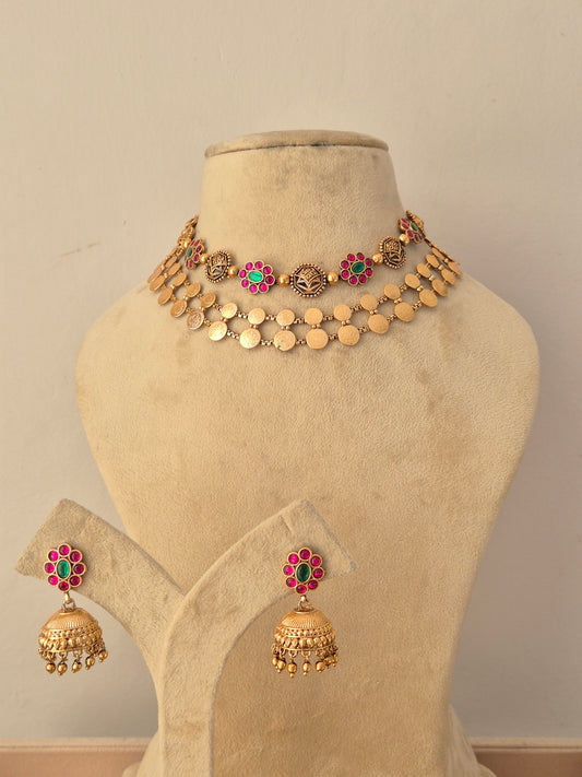 Traditional gold-plated layered choker necklace set with ruby and emerald-colored stone by Naitri.in