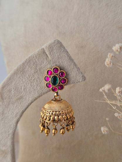 Ornate gold-toned fashion jewelry set with a detailed layered coin and choker design, paired with matching ethnic earrings by Naitri.in