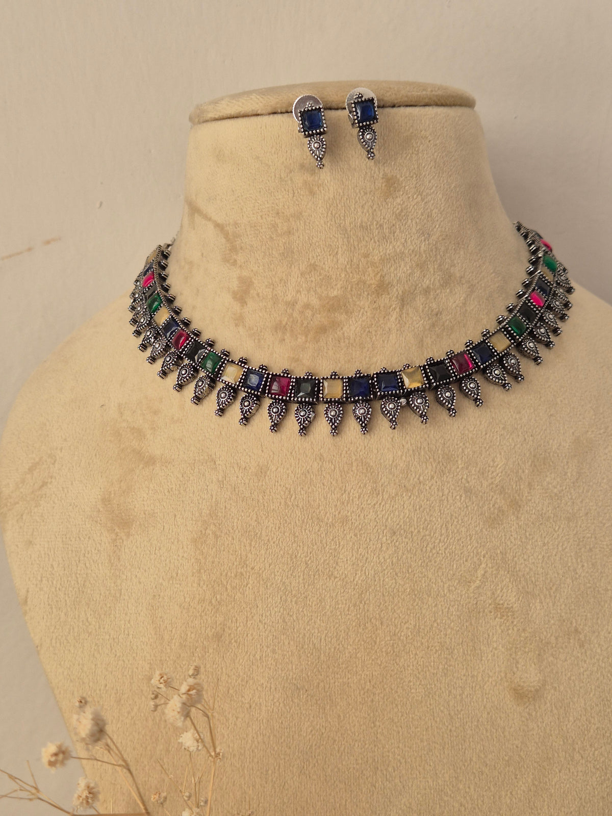 Oxidized silver brass alloy choker necklace set featuring classic Indian motifs and pearl accents by Naitri.in