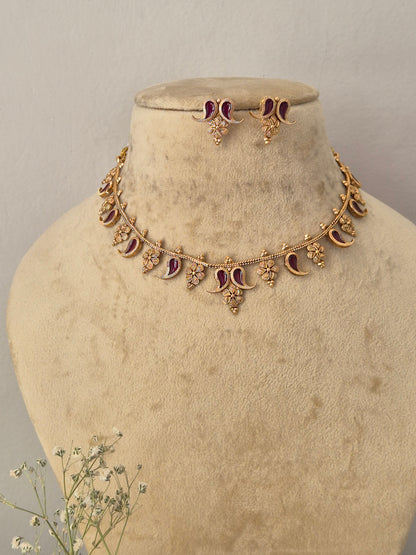 Traditional Indian gold-toned necklace set with floral and crescent metalwork details and deep wine enamel accents, by naitri.in