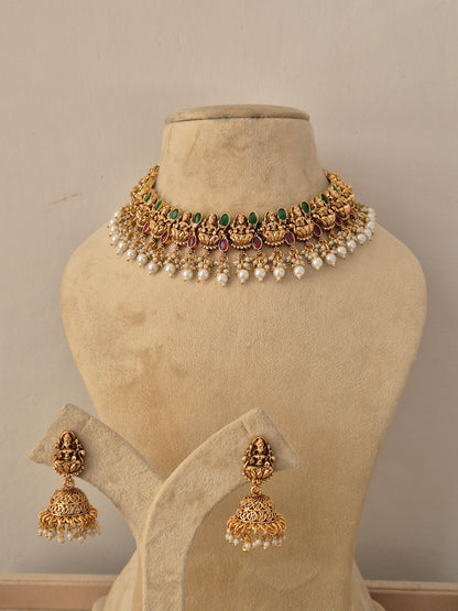 Shreya Necklace Set - Antique gold temple jewelry choker with matching jhumka earrings, adorned with stones and pearls by Naitri.in