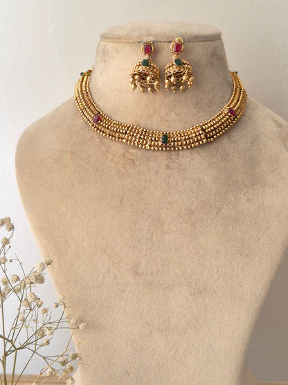 Traditional elegant necklace set with green and red stones with Jhumki available at naitri.in