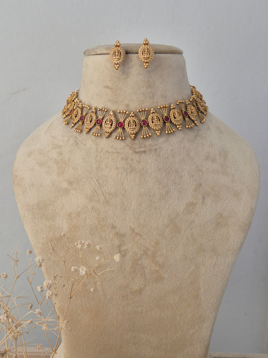 Contemporary and chic Sikha gold choker necklace set with ruby-colored stones and matching earrings by Naitri.in