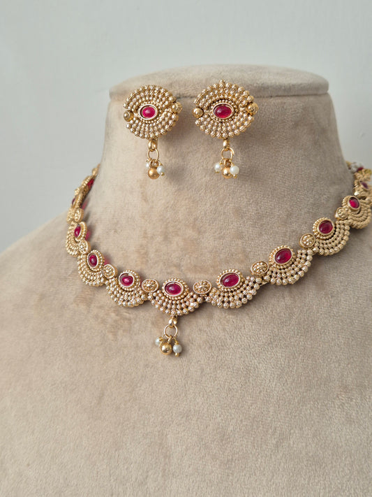Gold necklace with red stones necklace with same designed earring with red stones by naitri.in