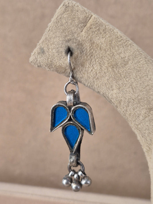 Pair of blue leaf-shaped glass drop earrings with silver bead detail. Sizu  blue glass dangle earrings with silver embellishments by naitri.in
