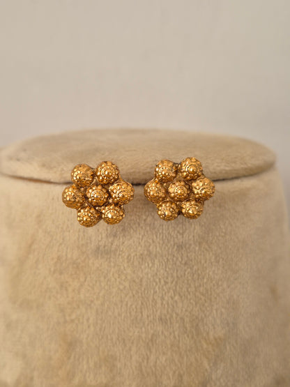 Traditional Indian gold-plated floral stud earrings with an intricate textured cluster design by Naitri.in