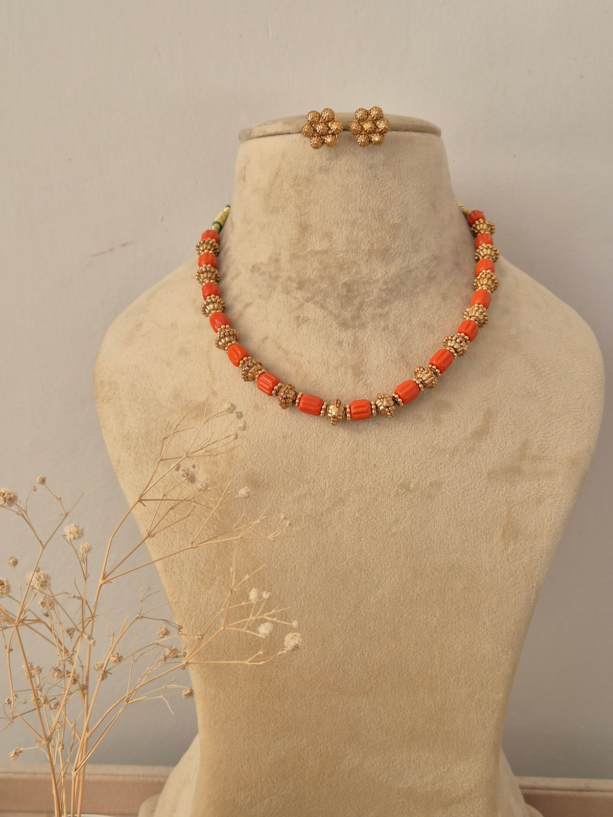 Sonakshi Necklace Set featuring orange beaded strands with gold accents and matching stud earrings by Naitri