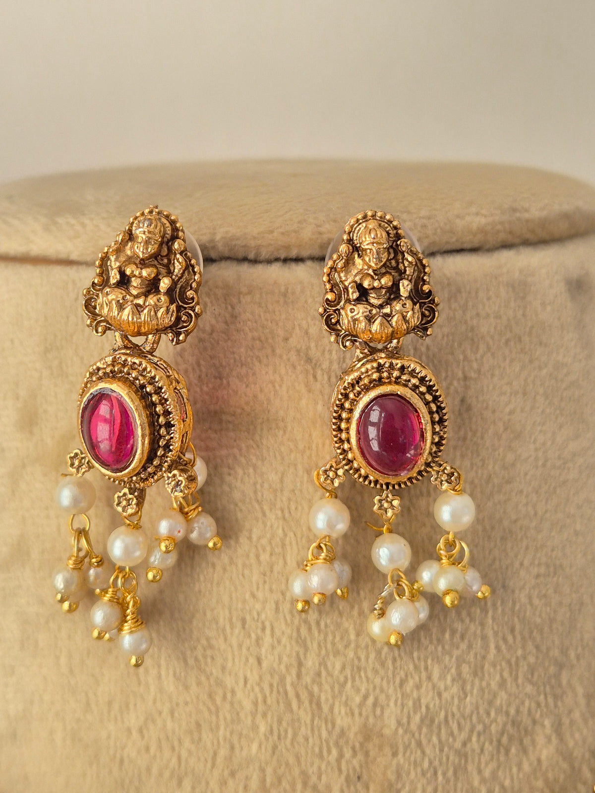 Ornate Temple Design Necklace and Earrings presented on a display bust, emphasizing the classic cultural motifs, textured antique gold plating, and traditional layered pearl elements ideal for special occasions and weddings by Naitri.in