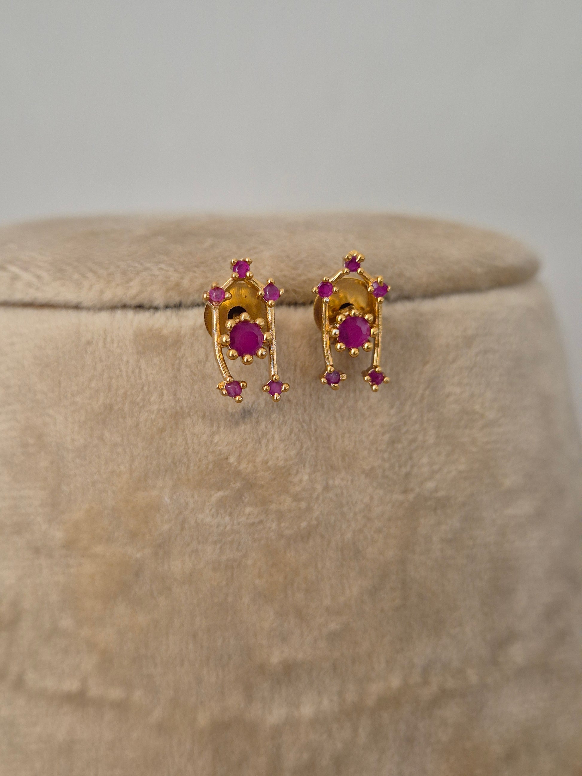 Modern Indian aesthetic earring with a dainty stone-studded ruby-red stones highlights, perfect for elegant ethnic or festive wear by naitri.in