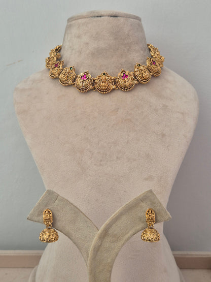 Suchi Necklace Set with Pink and Green Stones | Naitri Ethnic Jewellery. Traditional gold choker necklace  with pink ruby and green stone embellishments by naitri.in