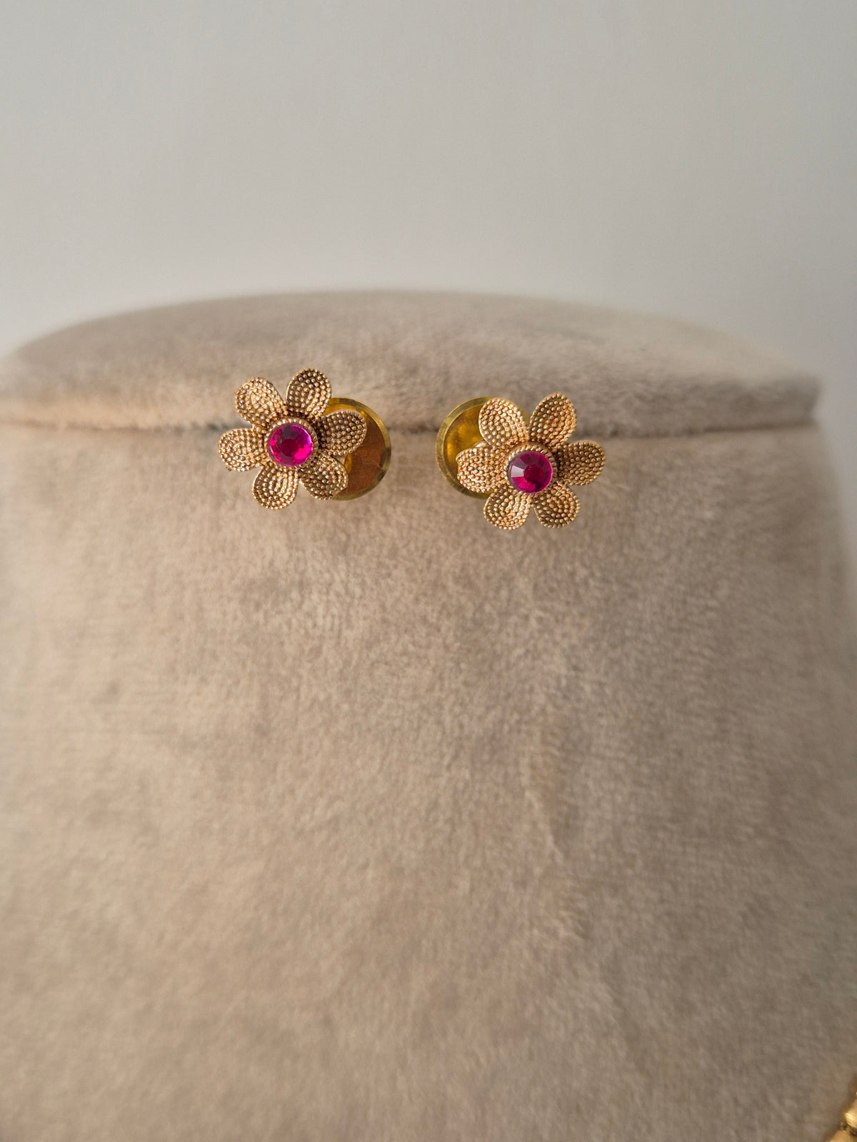 Gold flower-shaped earrings with pink gemstones minimal light weight earrings by naitri.in