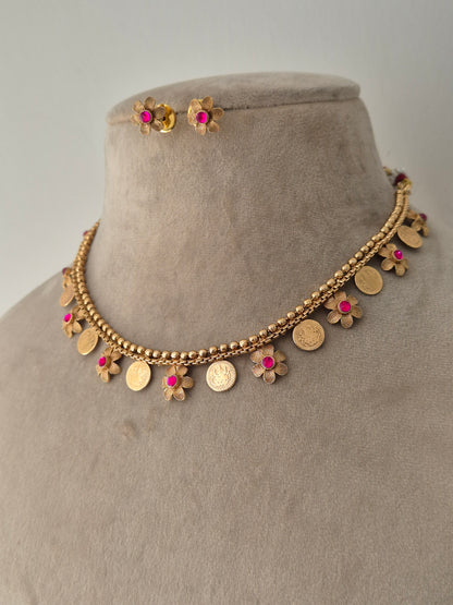 Gold necklace with floral and coin designs sleek and minimal design can be wear at any occasions by naitri.in