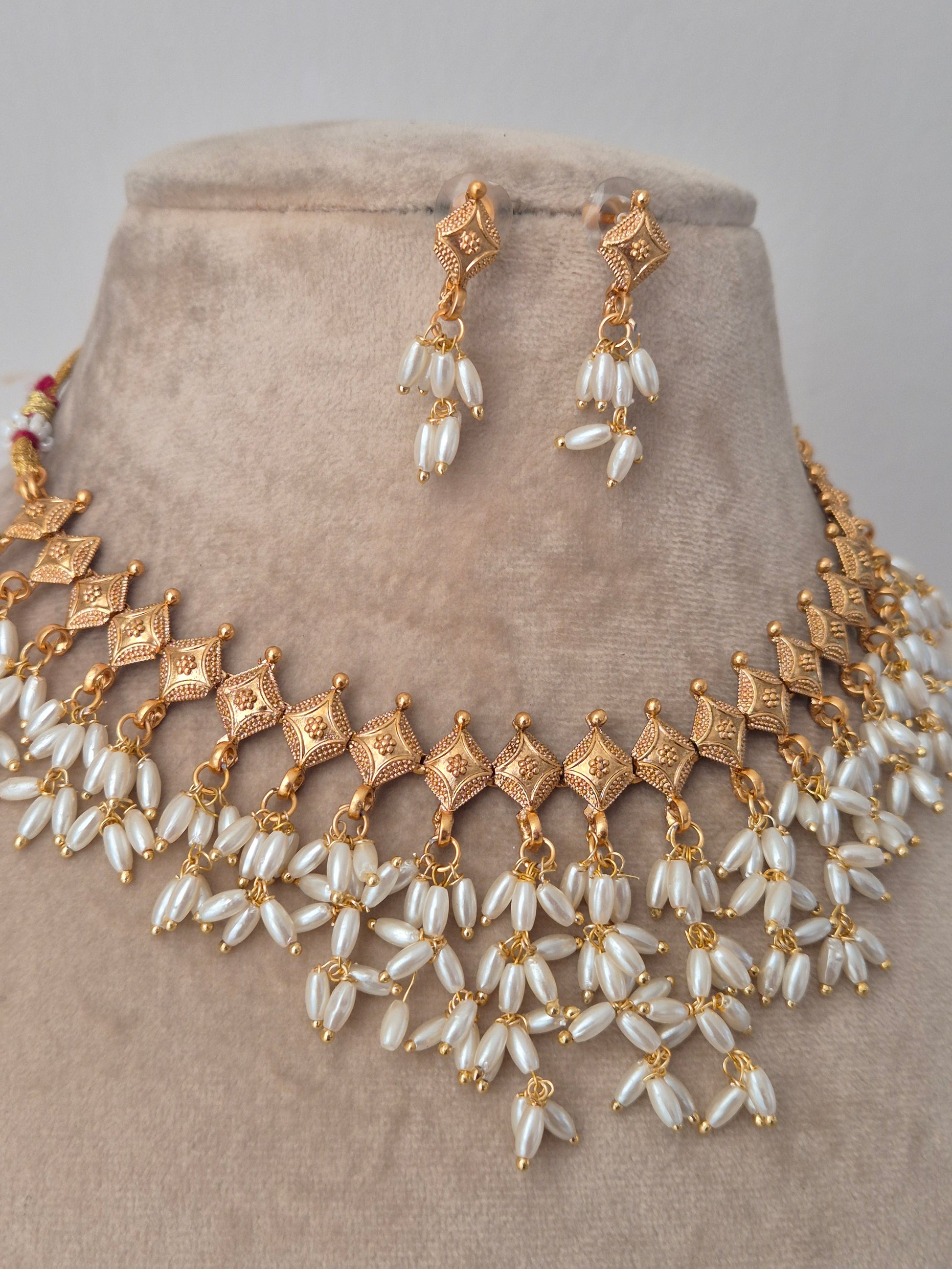 Gold and long shaped pearl jewelry perfect for wedding and festival light weight and easy to carry by naitri.in