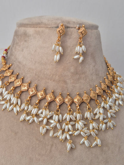 Gold and long shaped pearl jewelry perfect for wedding and festival light weight and easy to carry by naitri.in