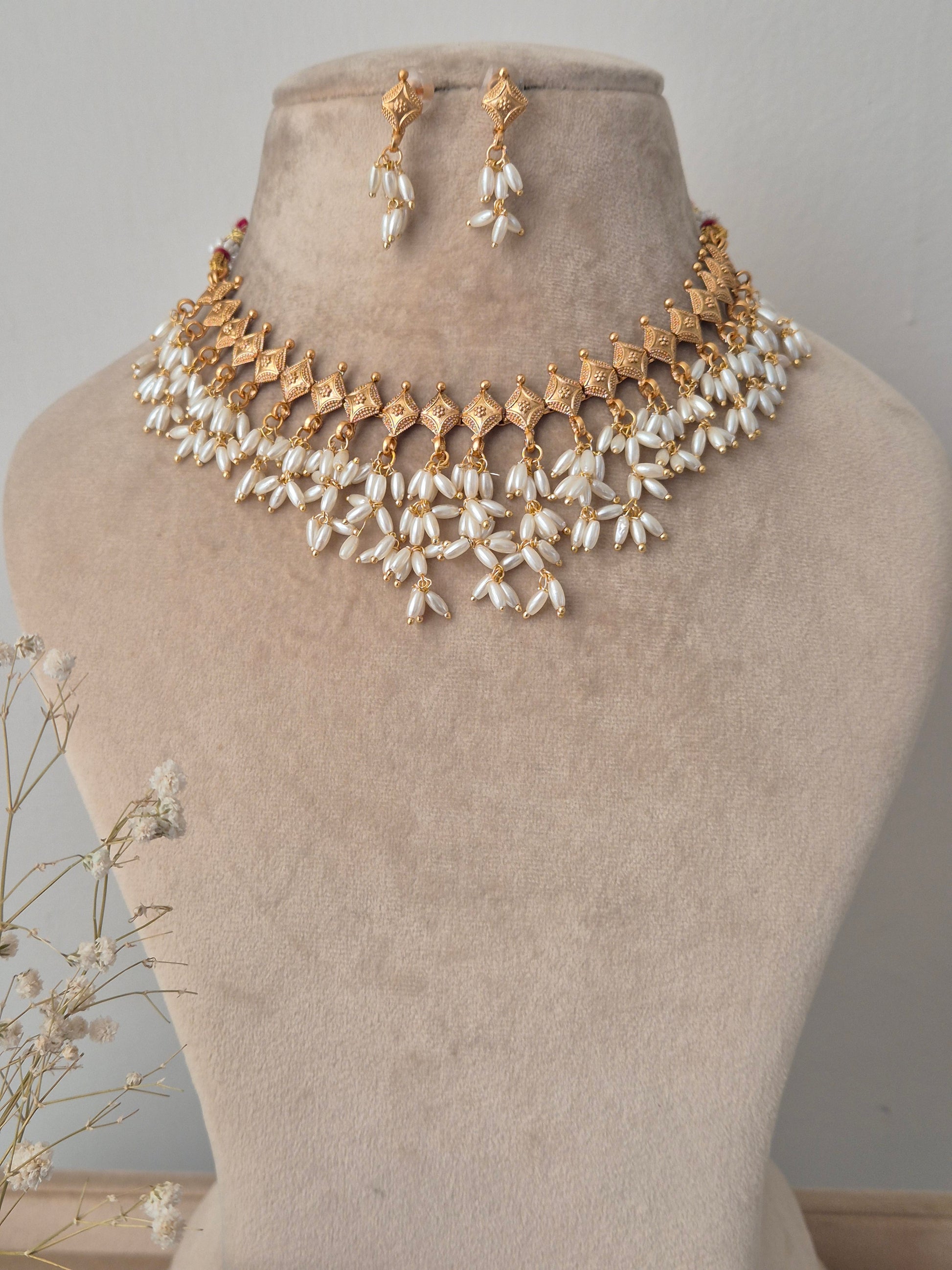 Gold and pearl necklace with same designed earrings, unique diamond necklace by naitri.in