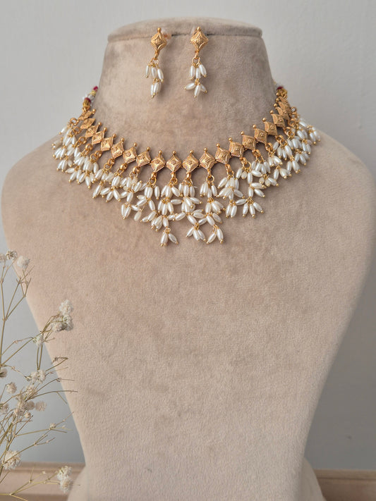 Gold and pearl necklace with same designed earrings, unique diamond necklace by naitri.in