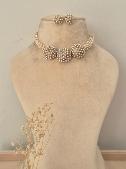 Traditional pearl and gold choker necklace dome-shaped pearl clusters connected by a pearl-embellished band with matching stud earrings by naitri.in