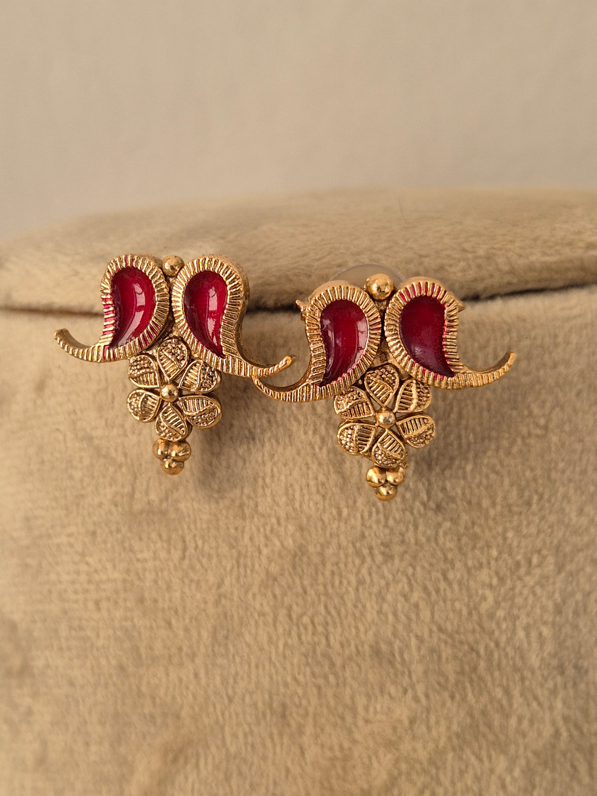 A pair of gold-toned traditional Indian jhumka earrings with red enamel, by naitri.in