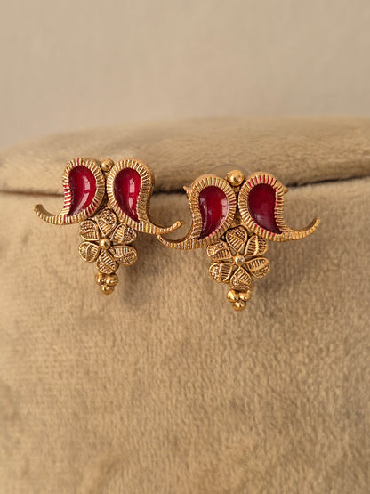 A pair of gold-toned traditional Indian jhumka earrings with red enamel, by naitri.in