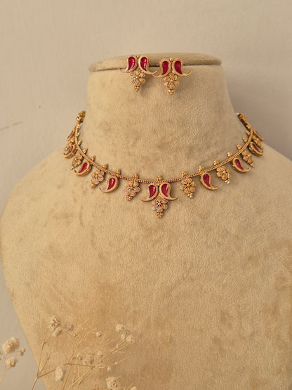 Traditional Indian gold-toned necklace set with floral and crescent metalwork details and red  enamel accents, by naitri.in