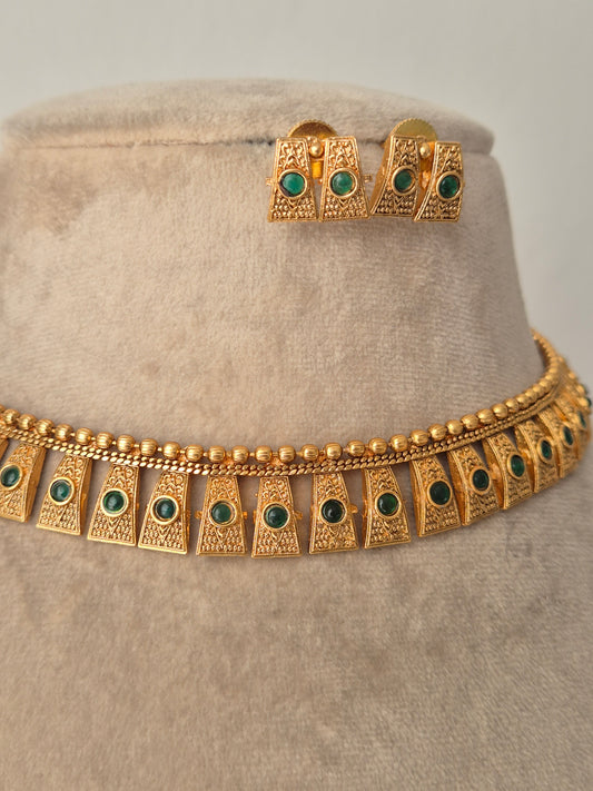 Gold necklace with green stones necklace with same designed earring with red stones by naitri.in