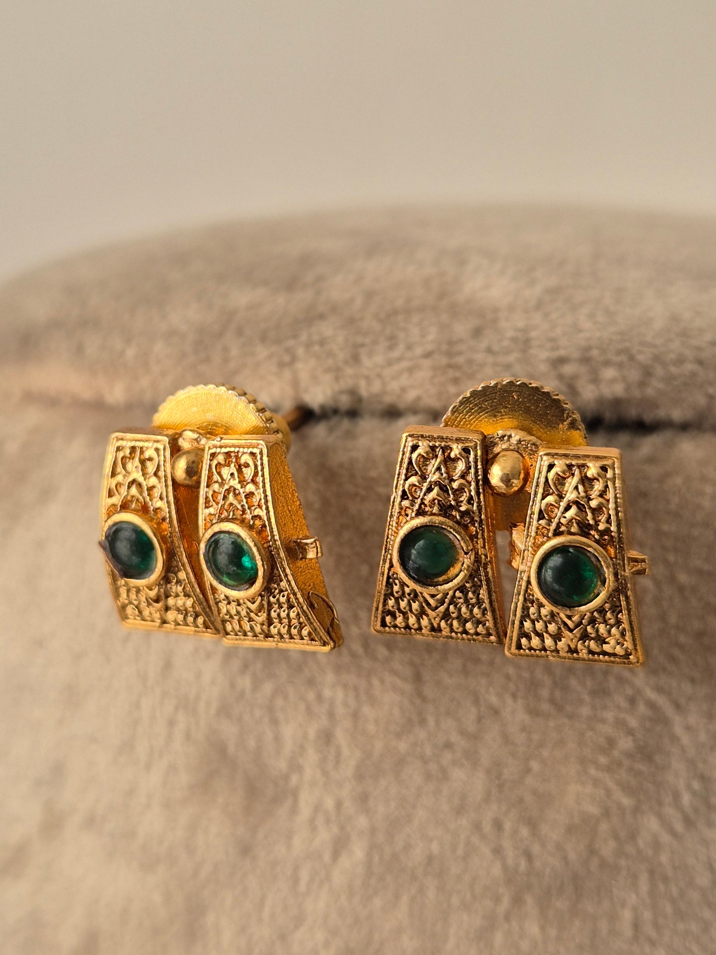 Gold earrings with green gemstones Handcrafted gold-plated brass Antique gold with Green-colored stone accents by naitri.in