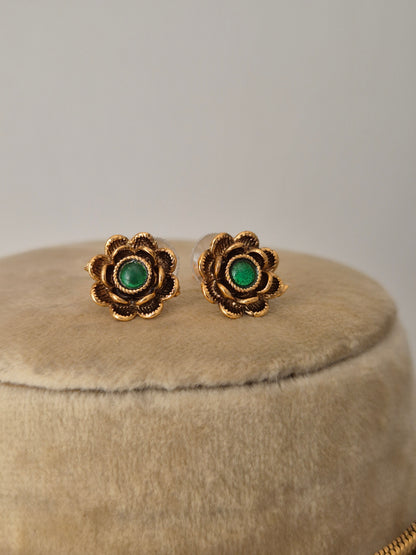 Traditional Indian floral earrings stud with green gemstones to showcase the modern Indian aesthetic by naitri.in
