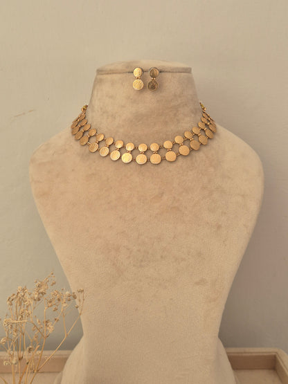 Traditional gold coin choker necklace set featuring double rows of overlapping coin discs matching small circular stud earrings by naitri.in