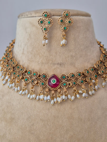 Artisanal gold-finish necklace set with geometric gold spacers and red stone accents, part of the Naitri Golden Jewellery collection with a modern Indian aesthetic by naitri.in