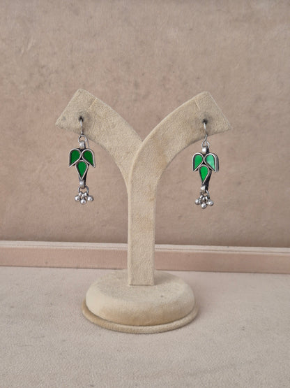 Glass Earrings featuring handcrafted green glass in a leaf design with small silver beads by naitri.in
