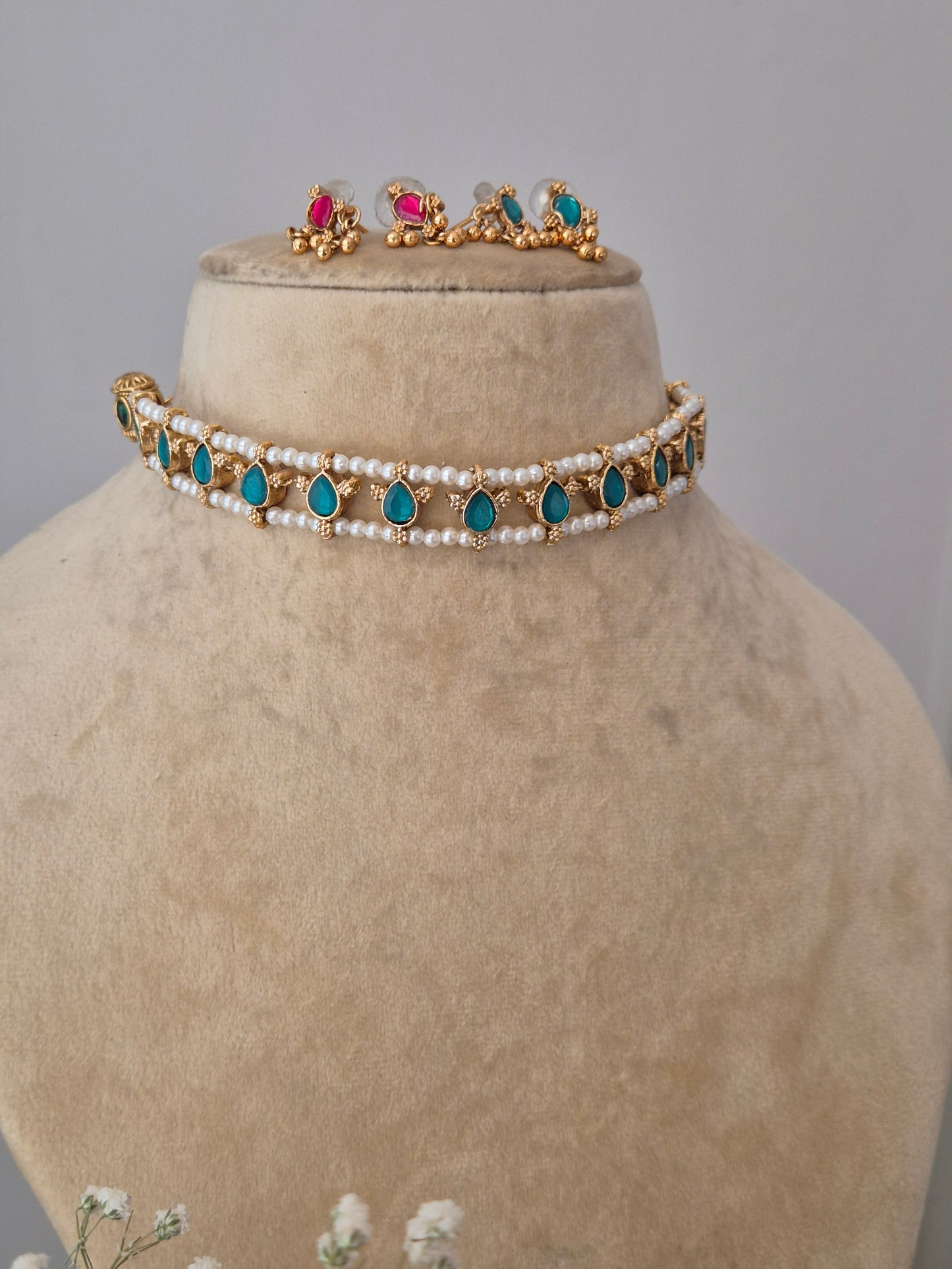Traditional gold and pearl choker with blue-pink accents, with  the artisanal finish by naitri.in