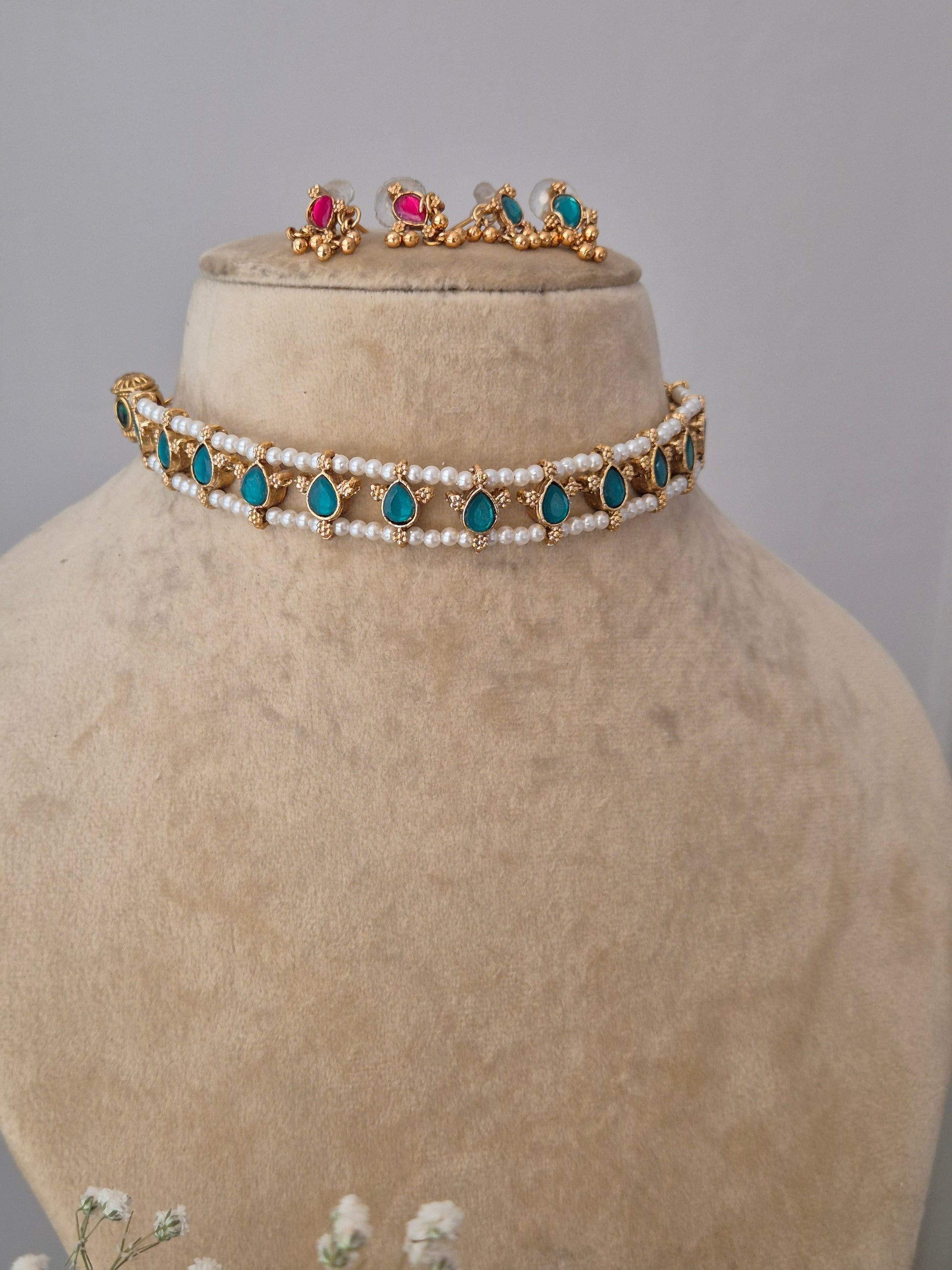 Traditional gold and pearl choker with blue-pink accents, with  the artisanal finish by naitri.in
