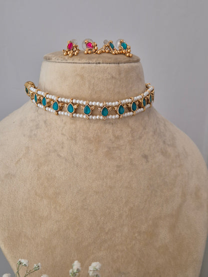 Traditional gold and pearl choker with blue-pink accents, with  the artisanal finish by naitri.in