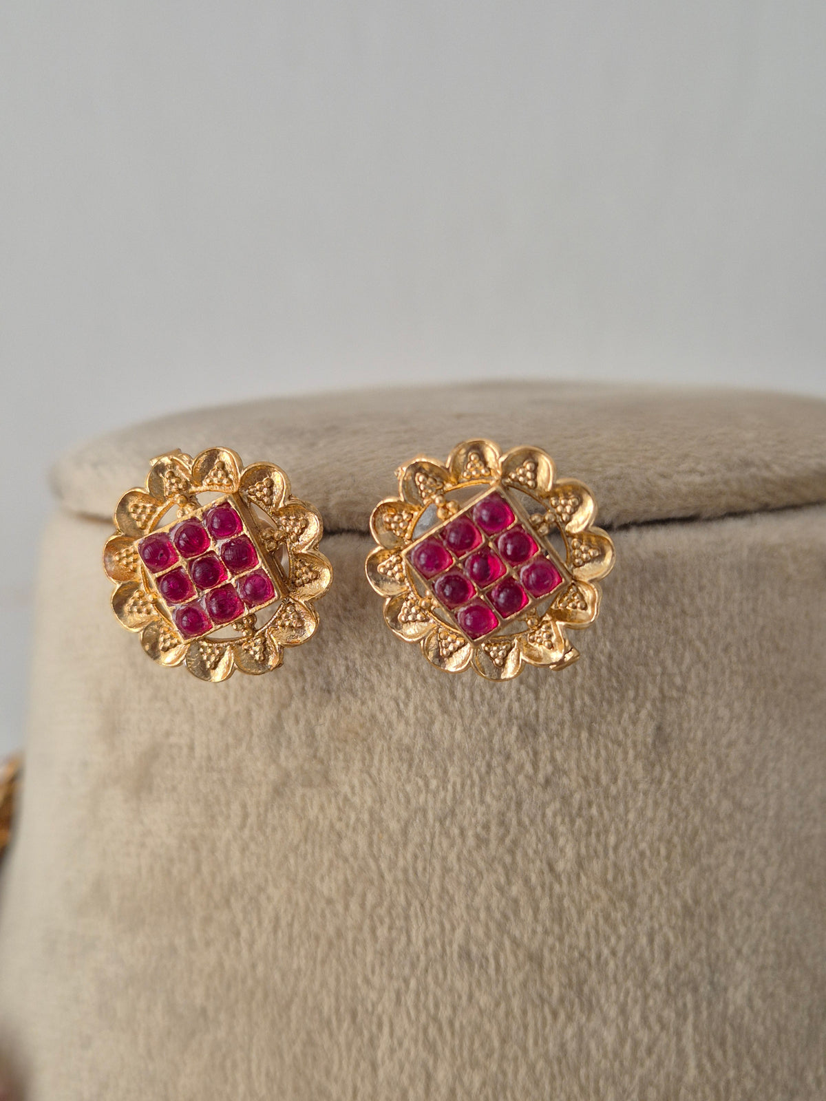 Ornate Designer Floral Necklace and Studs presented on a display bust, emphasizing the delicate petal details, rich golden texture, and timeless cultural appeal by Naitri.in