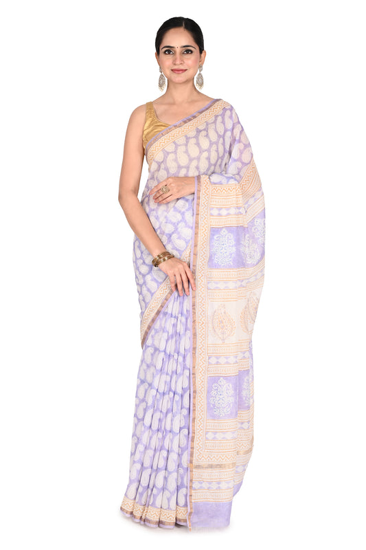 Woman wearing a light purple and beige Tiya Maheshwari Saree featuring traditional hand block prints and a gold-bordered cotton silk drape by naitri.in