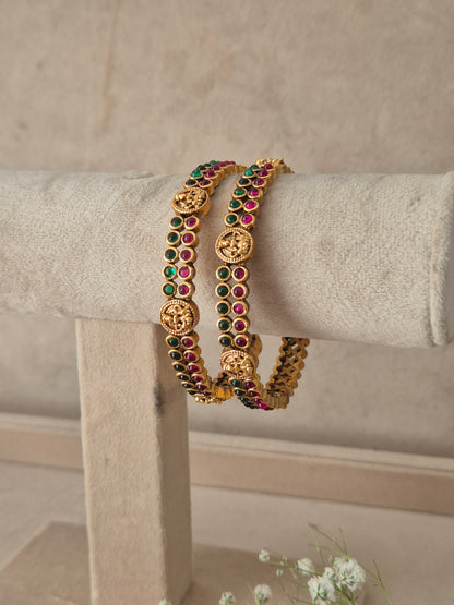 Set of two ornate traditional Indian bangles studded with pinkish-red and green gemstones, Antique gold-plated bangles set of 2 with red and green stones by naitri.in
