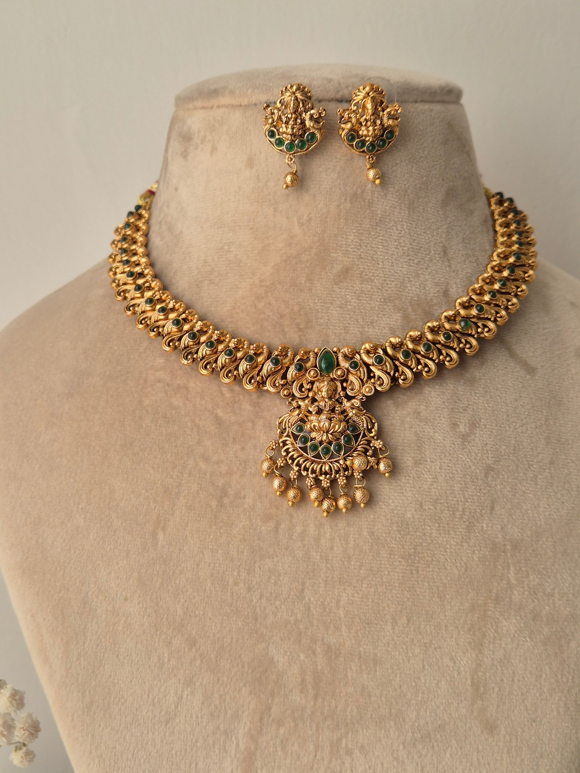 Handcrafted Masterpiece with lots  Detailing golden necklace and goddess motifs earrings with green stones