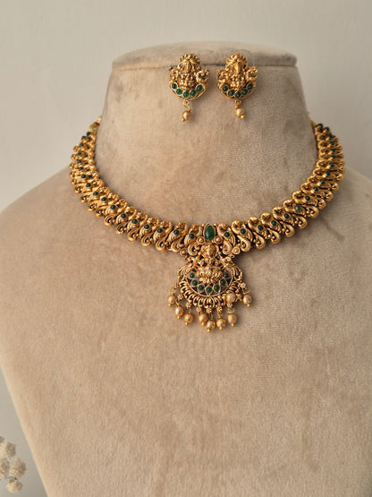Handcrafted Masterpiece with lots  Detailing golden necklace and goddess motifs earrings with green stones
